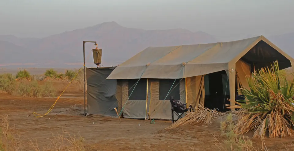 Mobile expedition guest tent with attached bathroom enclosure