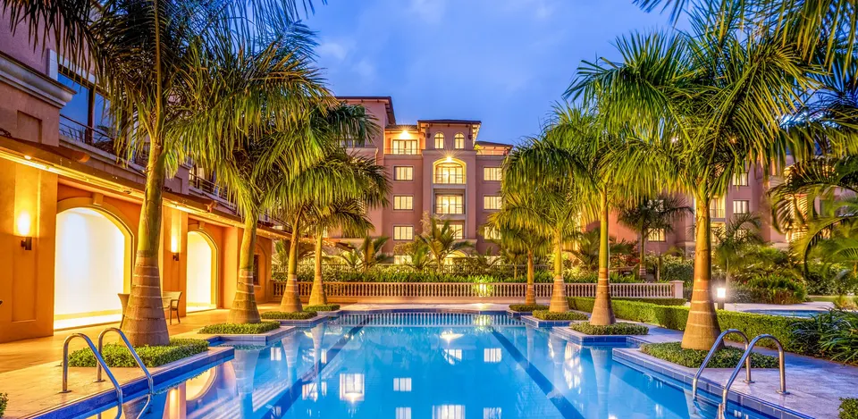 Méstil swimming pool and surrounding buildings at dusk