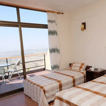 Panoramic View Hotel twin bedroom with balcony and highland outlook