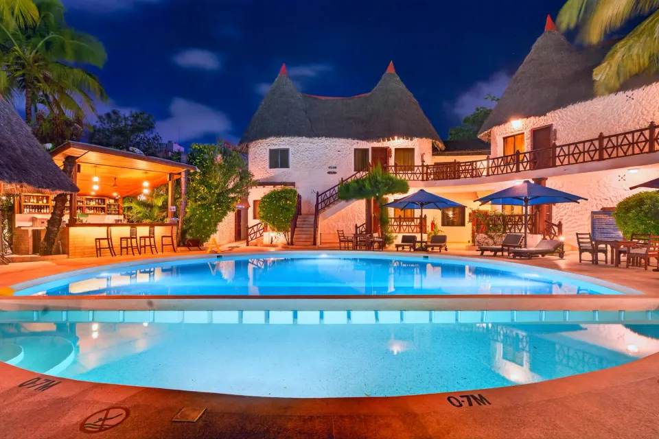 PrideInn Nyali swimming pool and buildings at dusk