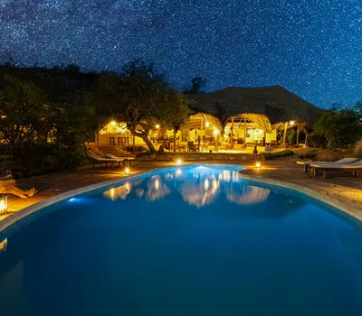 Kipalo Hills shared pool and main buildings at night