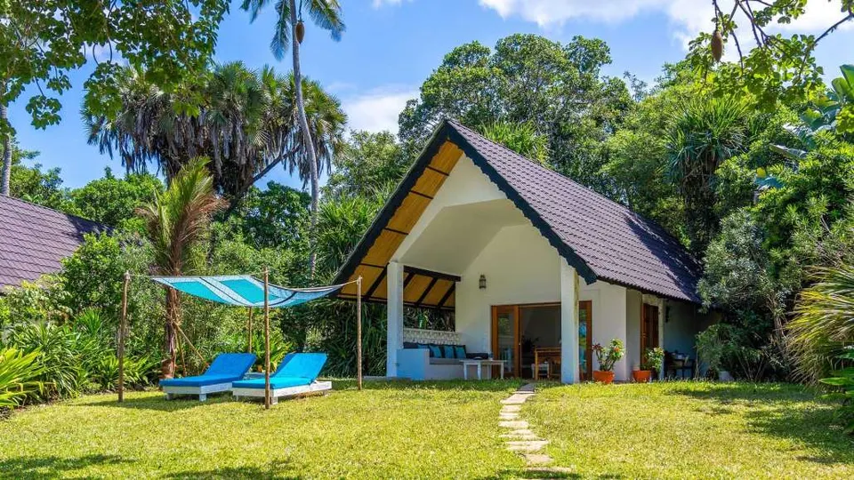 Nomad Beach Resort garden and thatched cottage exterior
