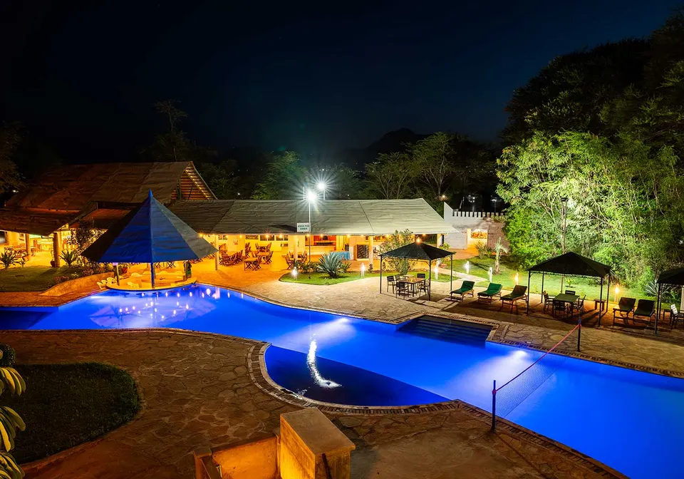 Voi Wildlife Lodge pool and buildings at night