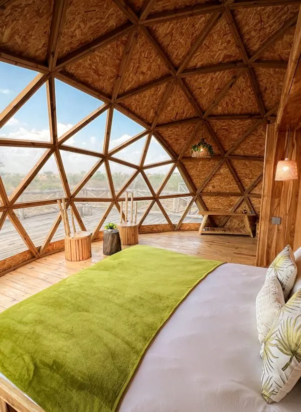Savana bedroom with bed and geometric timber/glass interior