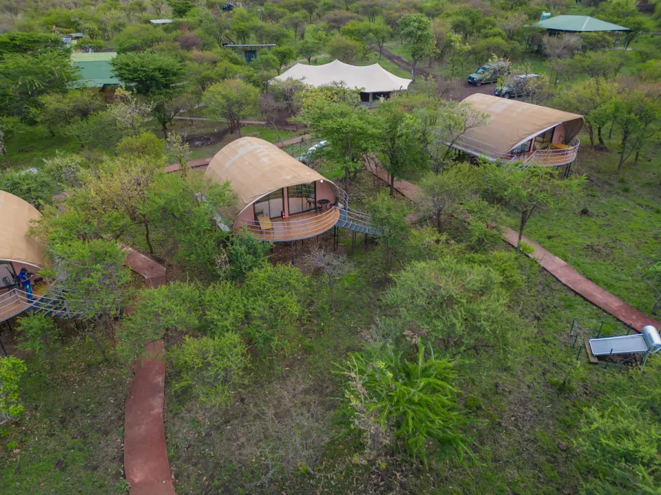 Aerial view of raised tents, paths and main buildings