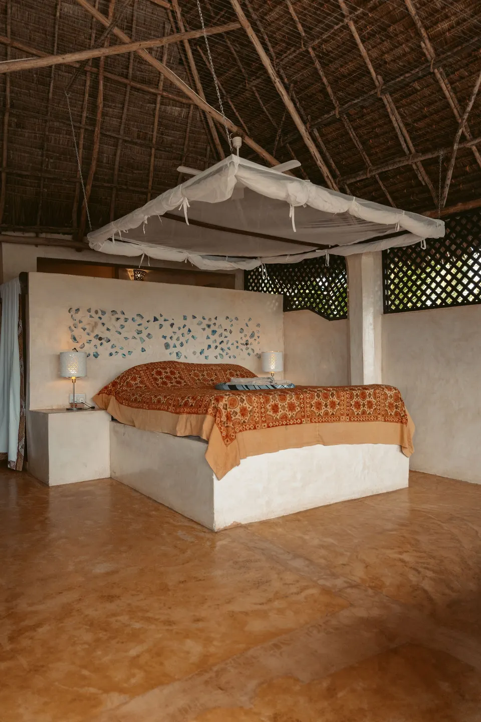 Banana House penthouse bedroom under makuti roof