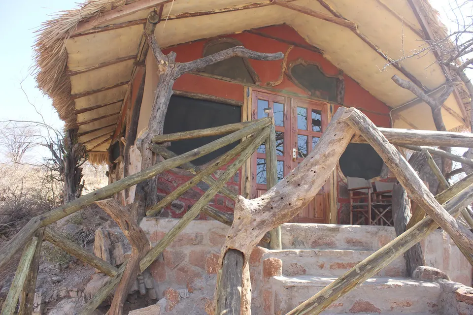 Lion’s Cave Camp rustic stone cottage exterior and stairs