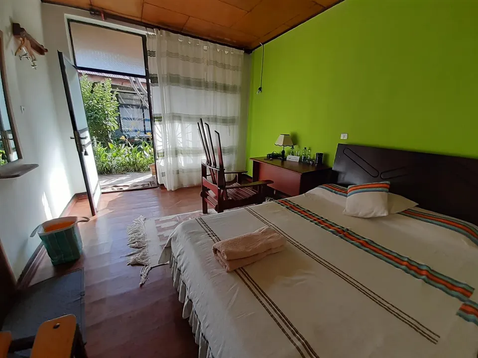 Guest bedroom with double bed and garden-facing doorway