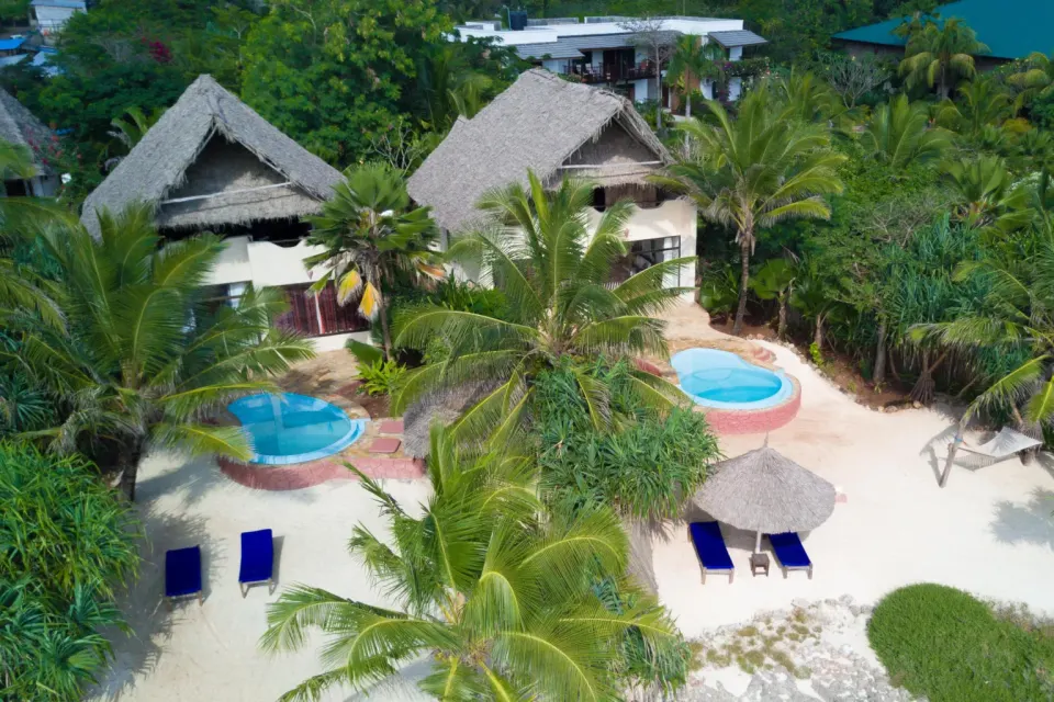 Thatched accommodation and pools in the gardens