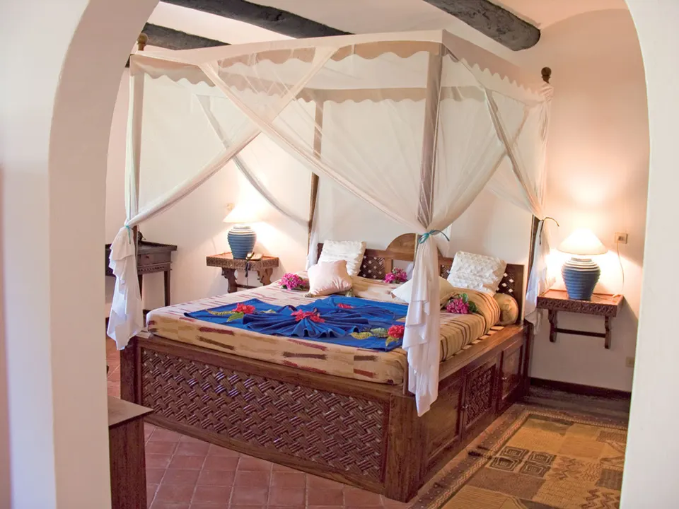 Dongwe Club guest room with canopy bed
