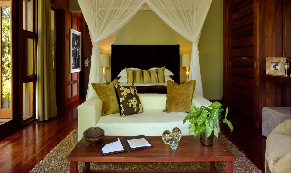 Chalet bedroom and sitting area at Lake Duluti Lodge