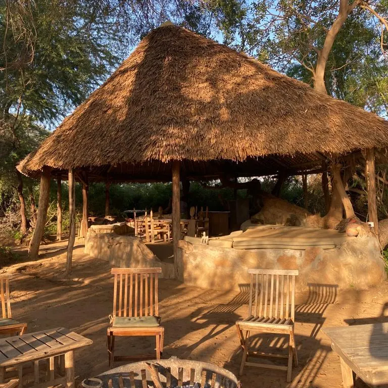 Lion King Bush Camp thatched communal dining shelter and outdoor chairs