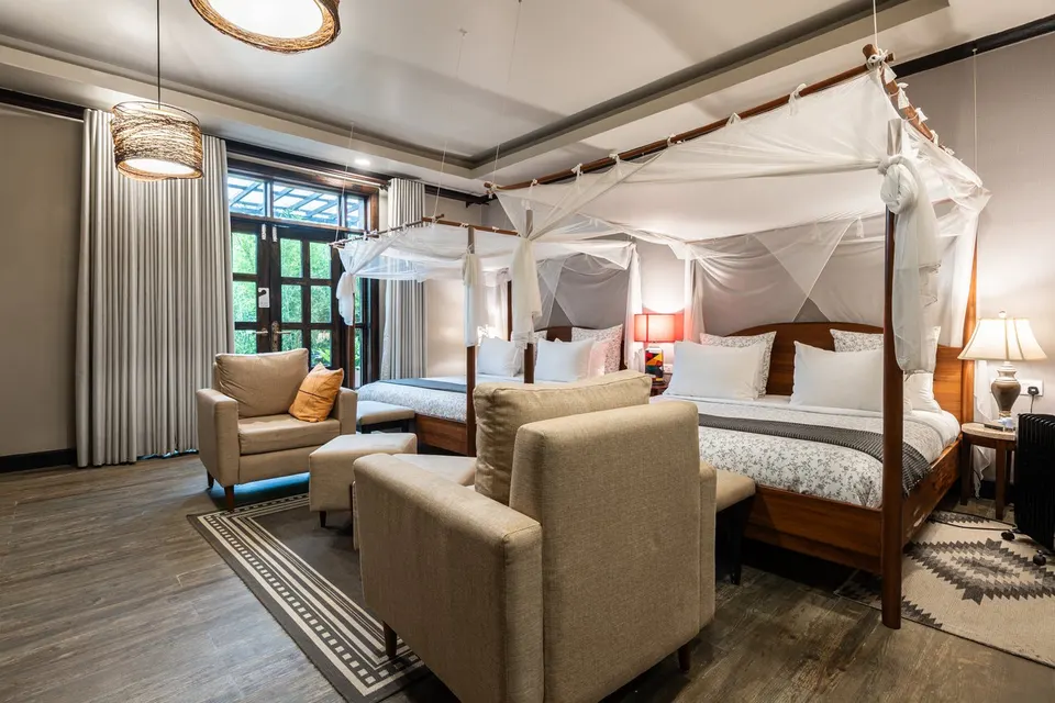 Twin Suite with two four-poster beds at the Volcano Manor, Five Volcanoes Boutique Hotel Rwanda