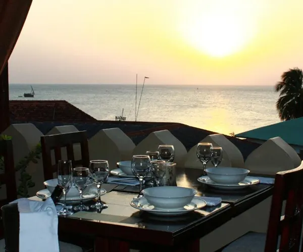 Rooftop dining table and coastal outlook shown by Al Johari