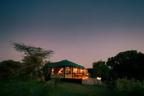 Olare Mara Kempinski tent exterior at dusk