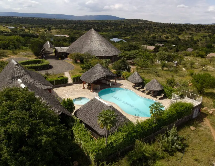 Aerial view of Enkorok Mara Camp pool and thatched buildings