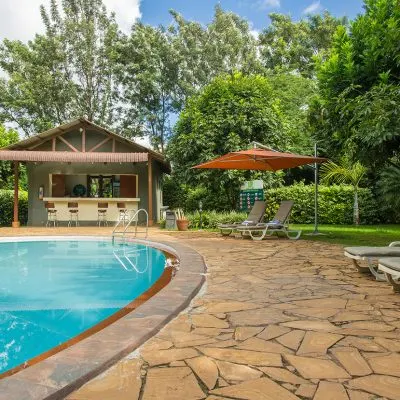 Poolside terrace and bar at Arusha Planet Lodge