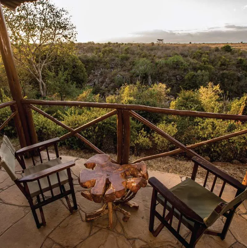 Maasai Lodge furnished veranda overlooking surrounding greenery