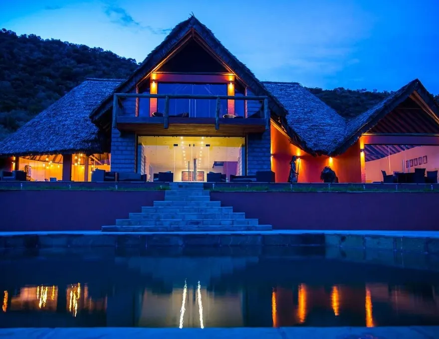 Ososian lodge exterior and pool at dusk