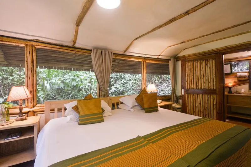 Chalet bed beside forest-facing windows