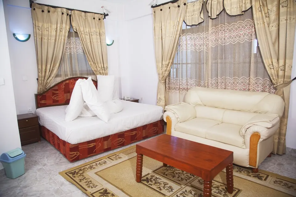 Guest bedroom and sofa at Natron Palace Hotel