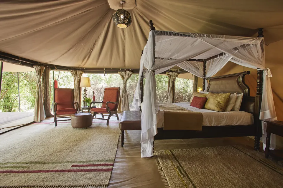 Mara Ngenche tent bedroom with indoor seating