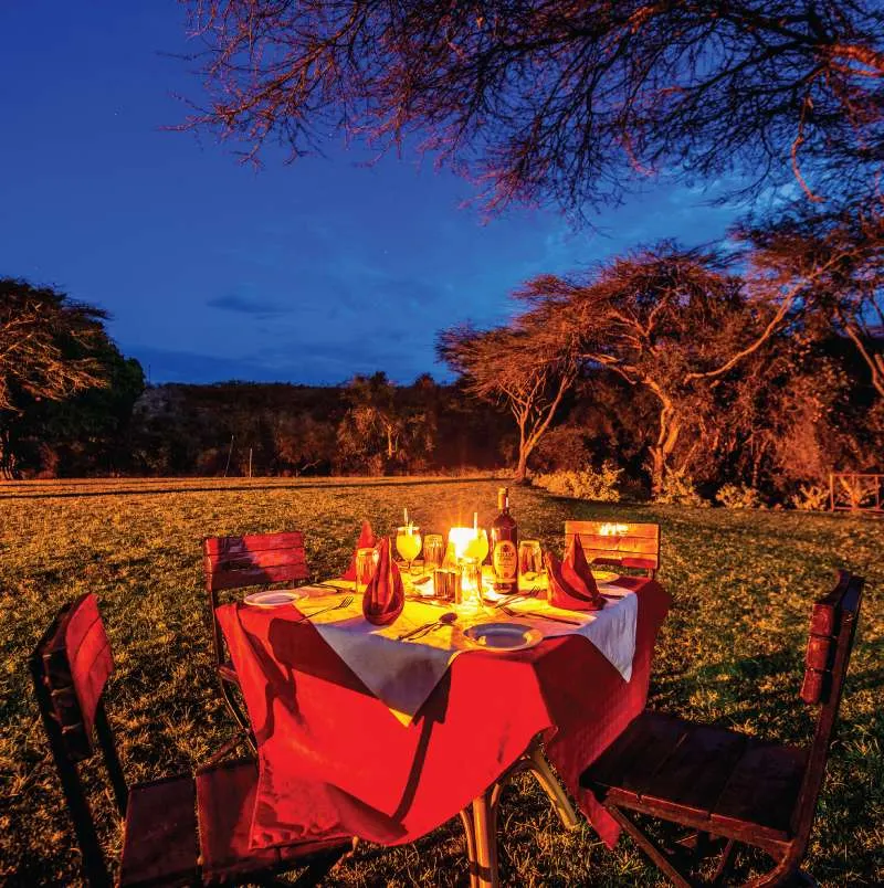 Maasai Lodge outdoor dinner setting at dusk