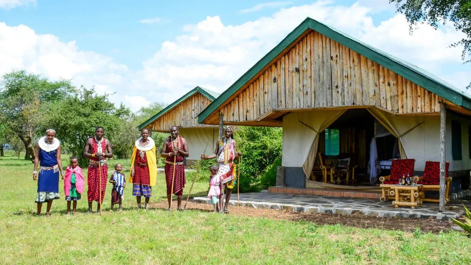 Main communal building at Africa Safari Serengeti Ikoma, with guests and local performers outside